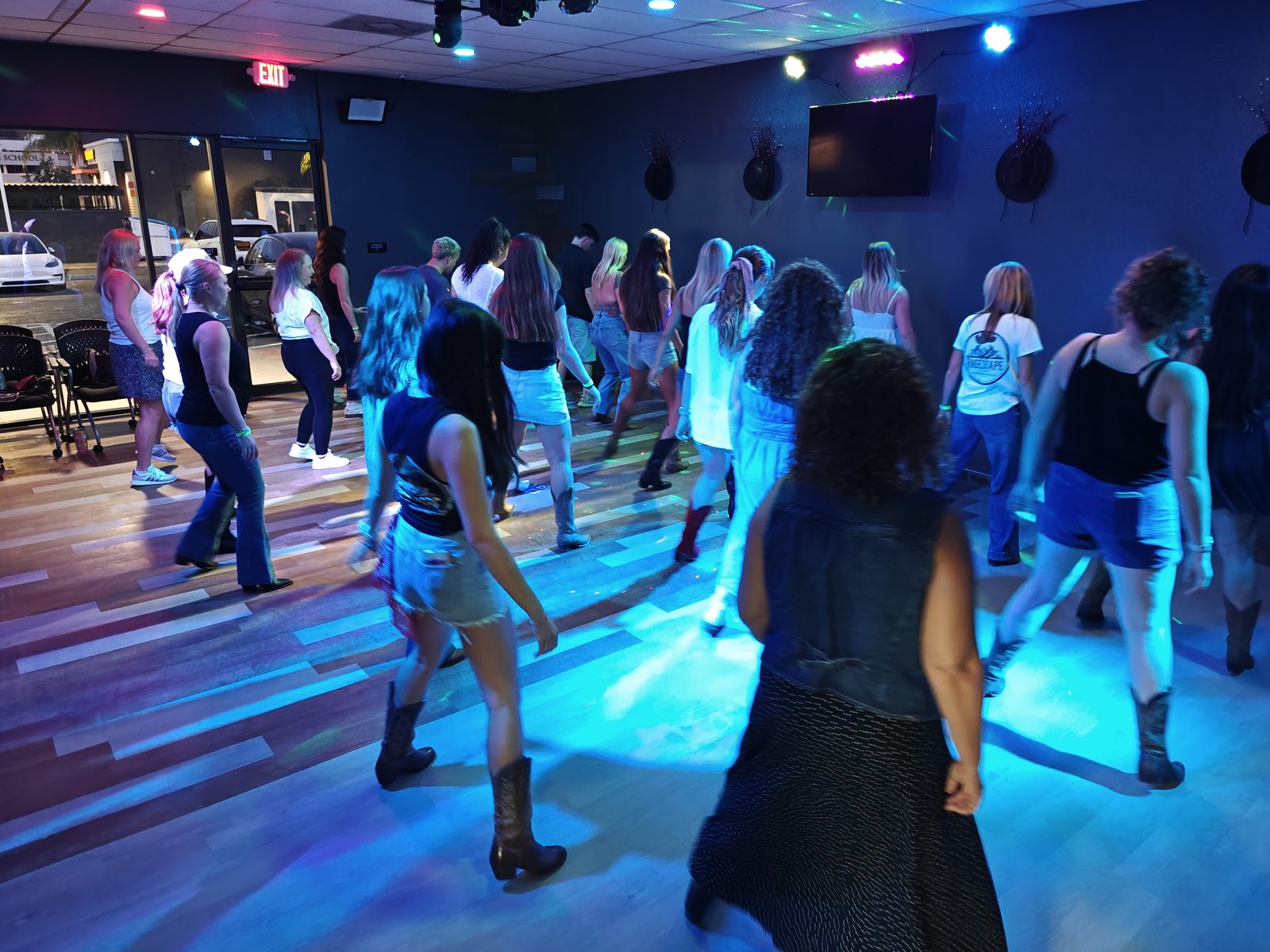 Guests line dancing at Tuesday Country Line Dance Night at Chopscape in Oceanside